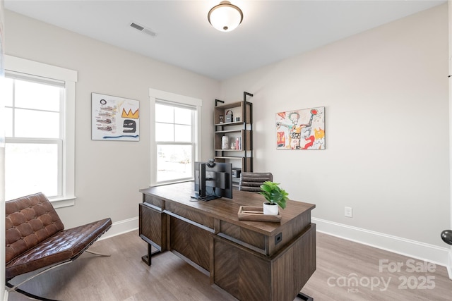 home office featuring wood-type flooring and plenty of natural light