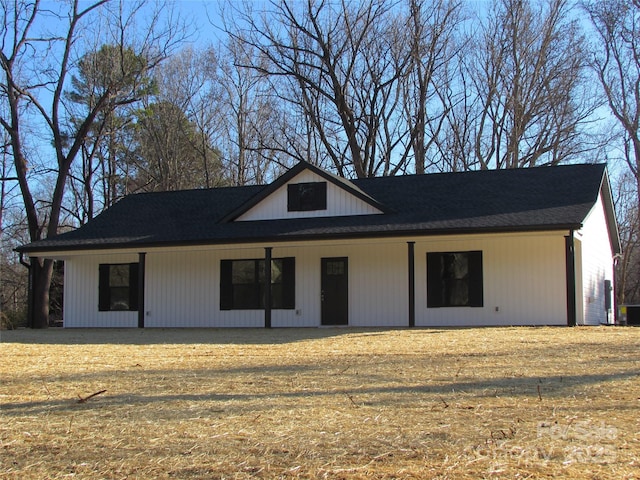 view of front of home with a front lawn and cooling unit