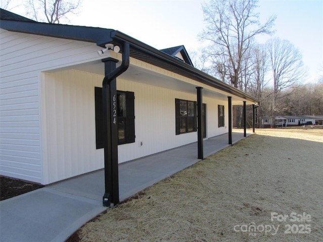 view of side of property with a patio