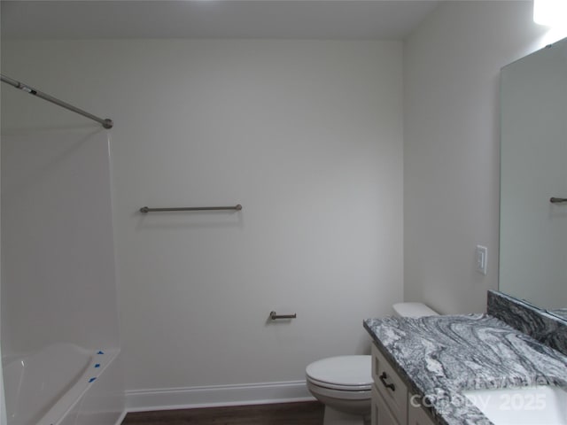 full bathroom with wood-type flooring, vanity, shower / bath combination, and toilet