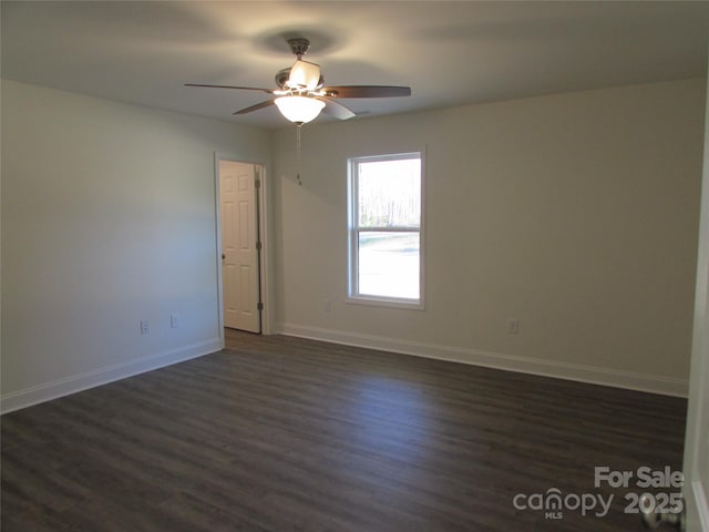 unfurnished room featuring ceiling fan and dark wood-type flooring