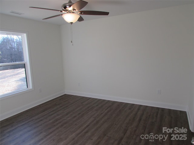 spare room featuring dark hardwood / wood-style floors and ceiling fan