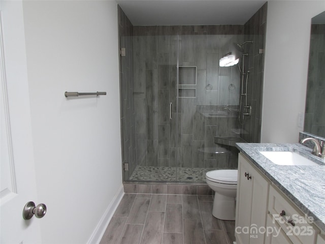 bathroom featuring vanity, toilet, and walk in shower