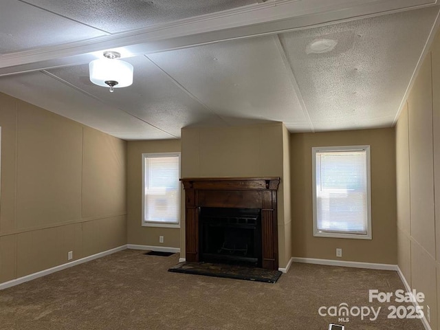 unfurnished living room with carpet flooring and vaulted ceiling