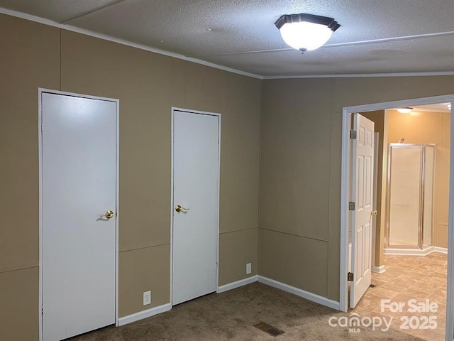 unfurnished bedroom featuring light colored carpet, a textured ceiling, and vaulted ceiling