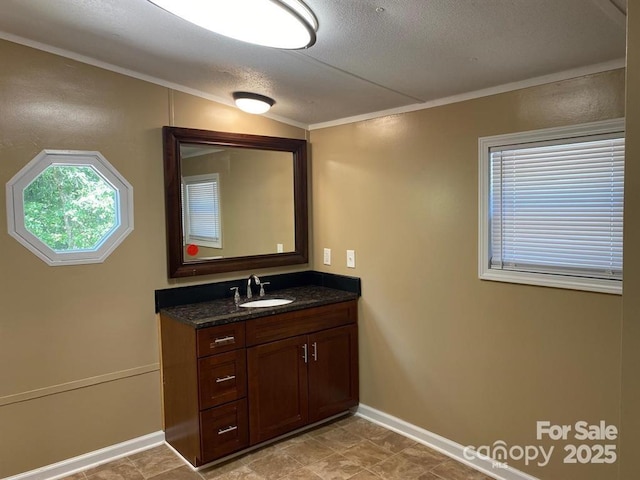 bathroom featuring ornamental molding, vanity, a textured ceiling, and lofted ceiling