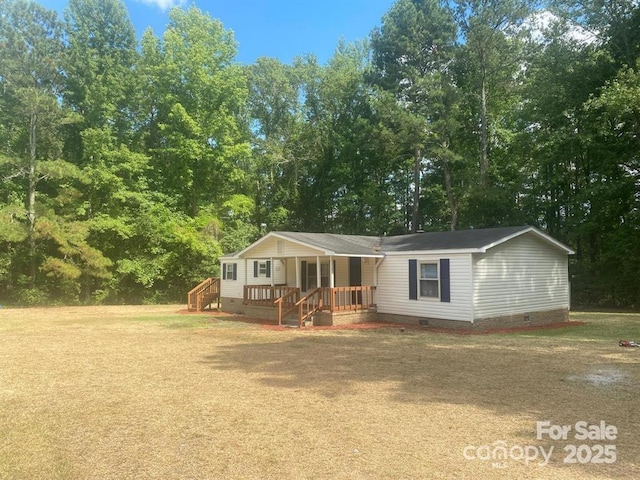 manufactured / mobile home with a porch and a front yard