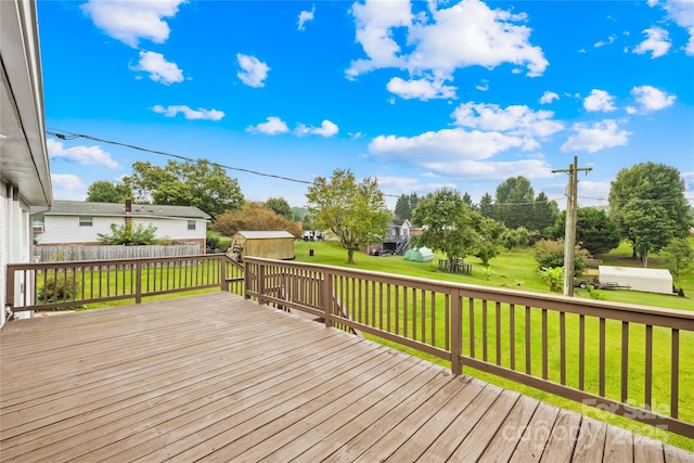 deck featuring a yard and a storage shed