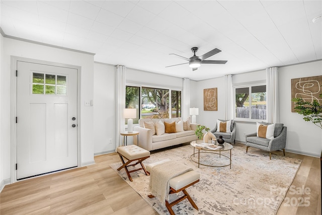 living room with light wood-type flooring and ceiling fan