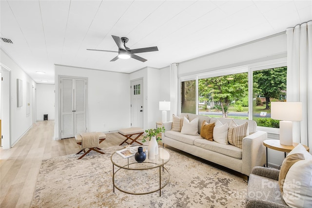 living room with light hardwood / wood-style floors and ceiling fan