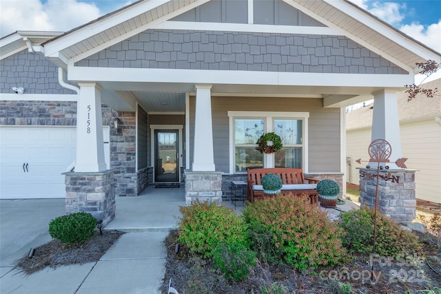 view of exterior entry with a porch