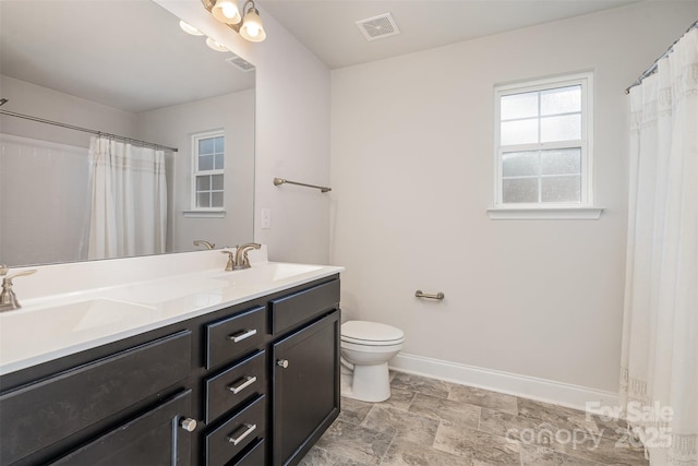 bathroom with vanity, toilet, and walk in shower