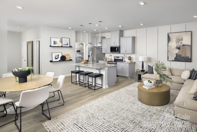 living room featuring light hardwood / wood-style floors and sink