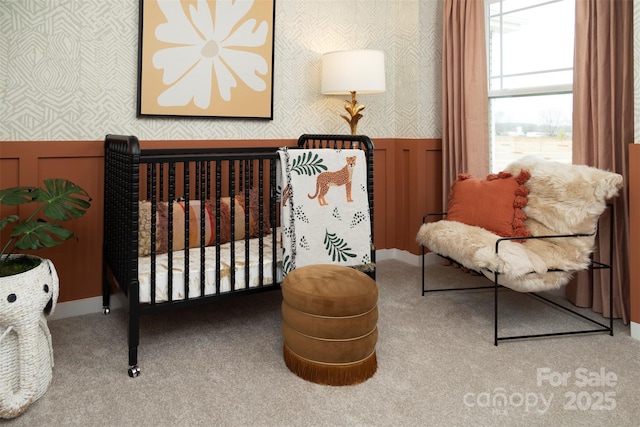 carpeted bedroom with a crib