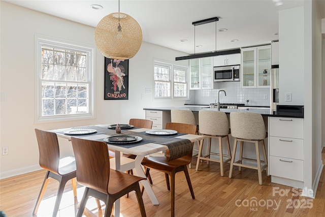 dining space featuring light wood-type flooring