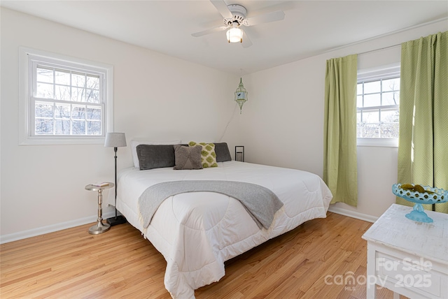 bedroom with hardwood / wood-style floors and ceiling fan