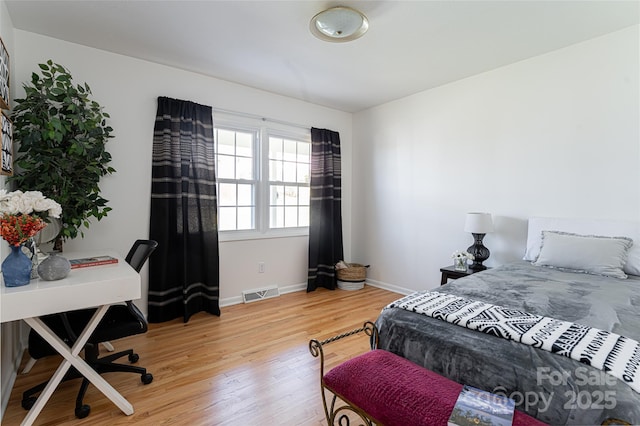 bedroom with wood-type flooring