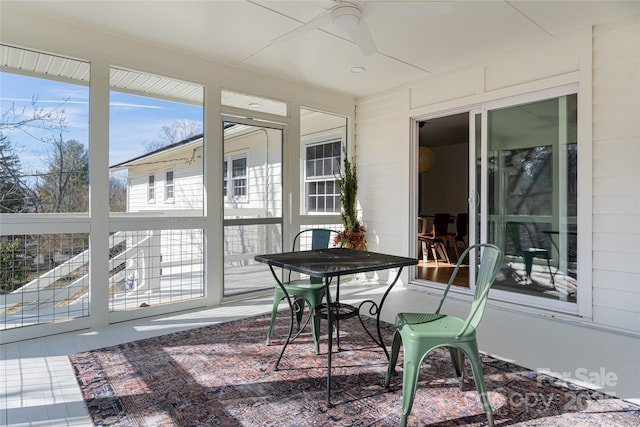 sunroom / solarium featuring ceiling fan