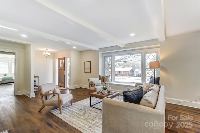 living room with beam ceiling, dark wood-type flooring, and a chandelier