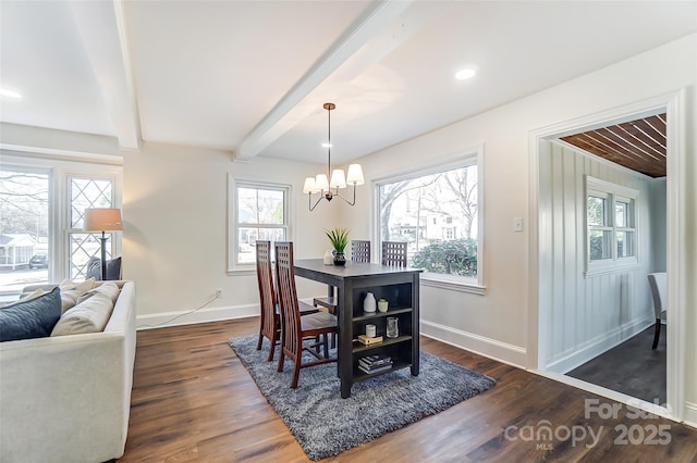 dining space featuring beamed ceiling, dark hardwood / wood-style flooring, a wealth of natural light, and an inviting chandelier