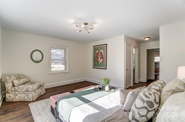 bedroom featuring a chandelier and dark hardwood / wood-style flooring