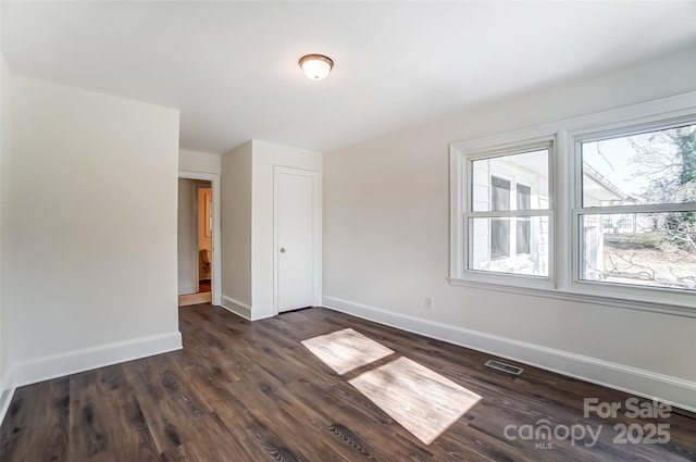 spare room featuring dark hardwood / wood-style flooring