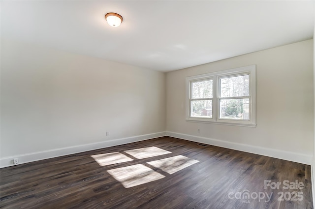 empty room with dark hardwood / wood-style floors