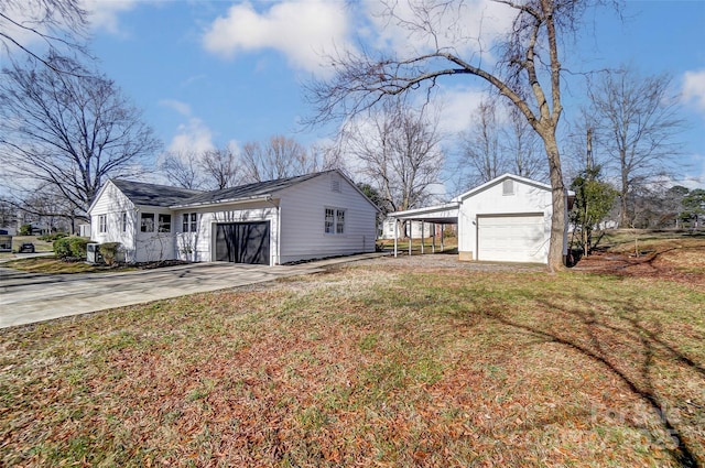 view of side of home with a carport, a garage, and a lawn