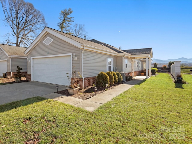 view of property exterior with a mountain view, central AC, a garage, and a lawn