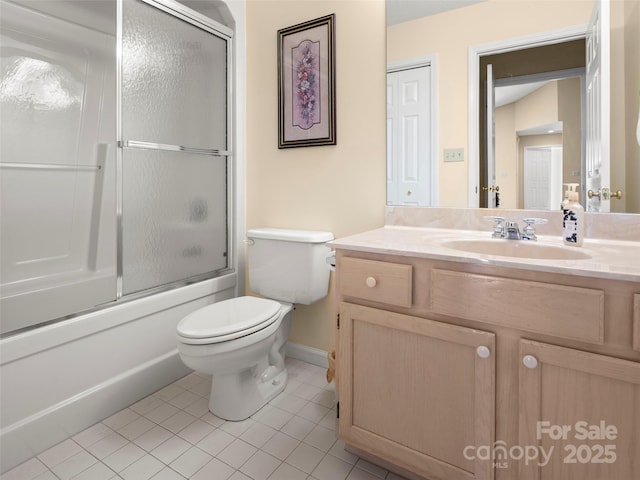 full bathroom featuring toilet, vanity, tile patterned floors, and bath / shower combo with glass door