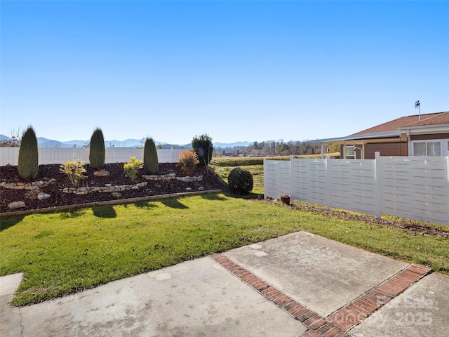 view of yard featuring a mountain view and a patio