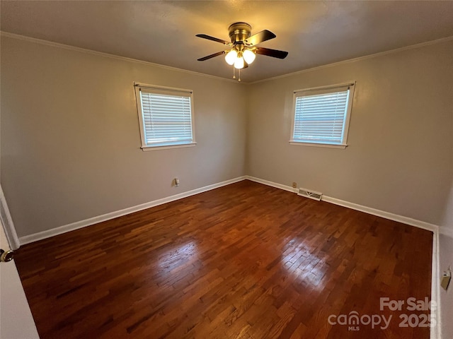 unfurnished room with ceiling fan, ornamental molding, and dark wood-type flooring