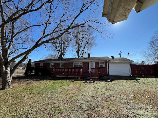 single story home with a front yard and a deck