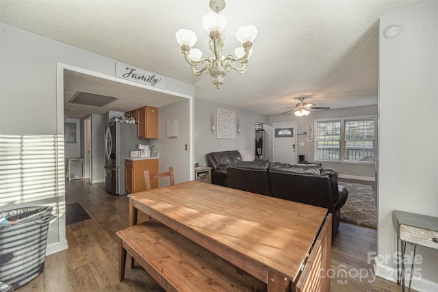 dining area featuring a textured ceiling, dark hardwood / wood-style floors, and ceiling fan with notable chandelier