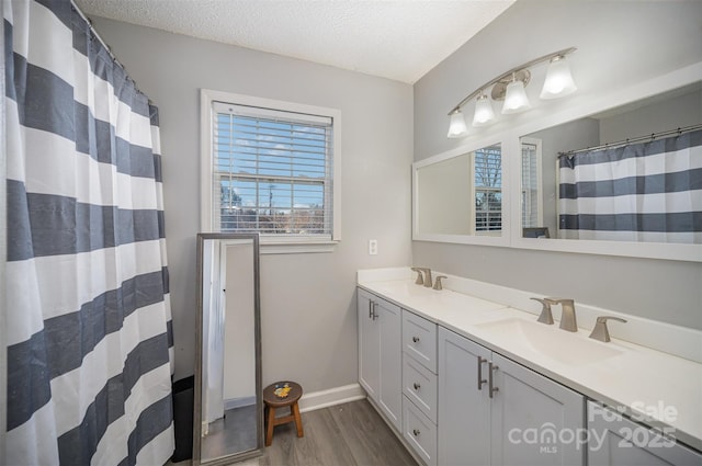 bathroom featuring vanity, wood-type flooring, a textured ceiling, and a shower with shower curtain