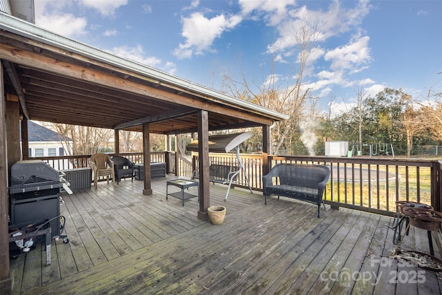 wooden terrace with a grill