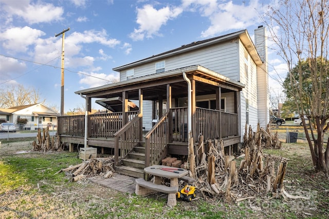 rear view of house featuring a deck