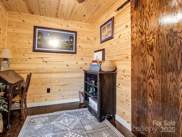 living area featuring dark hardwood / wood-style floors, wood walls, and wood ceiling