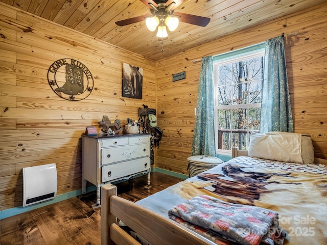 bedroom featuring ceiling fan, dark wood-type flooring, wood ceiling, and wood walls