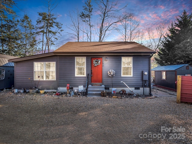 view of front of property with a storage shed