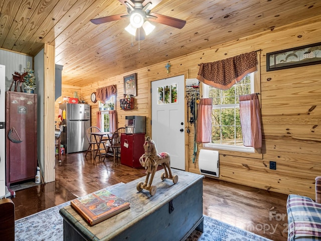 living room with dark hardwood / wood-style floors, ceiling fan, wood walls, and wood ceiling