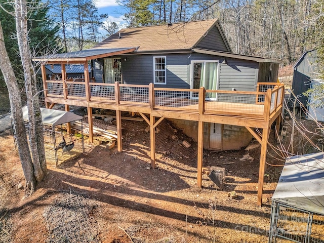 back of house with a wooden deck