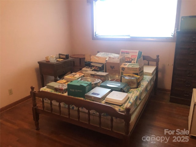 bedroom with dark hardwood / wood-style flooring