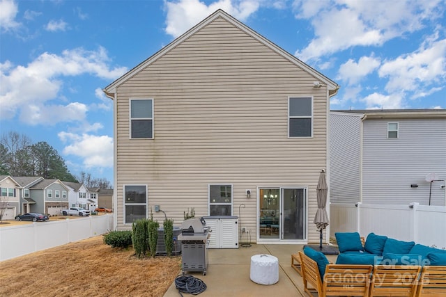 back of property with outdoor lounge area and a patio area