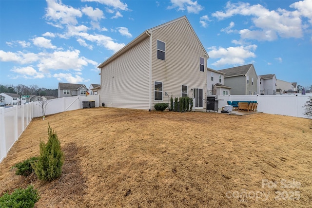 rear view of house with a yard