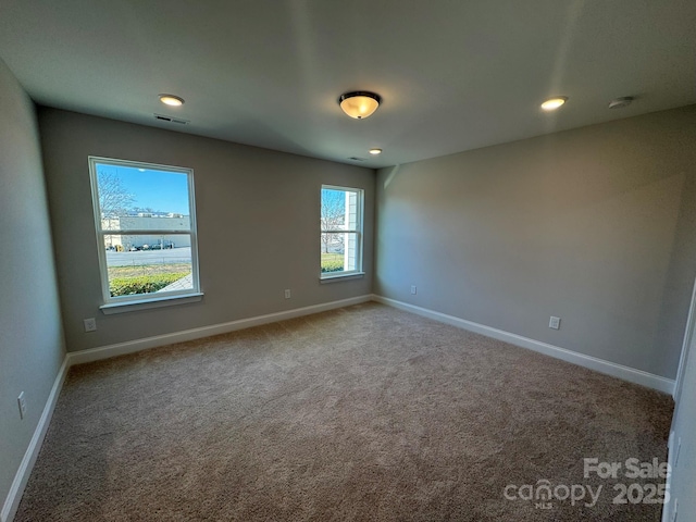 spare room featuring recessed lighting, baseboards, visible vents, and carpet flooring