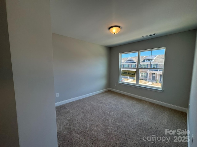 carpeted empty room with baseboards and visible vents