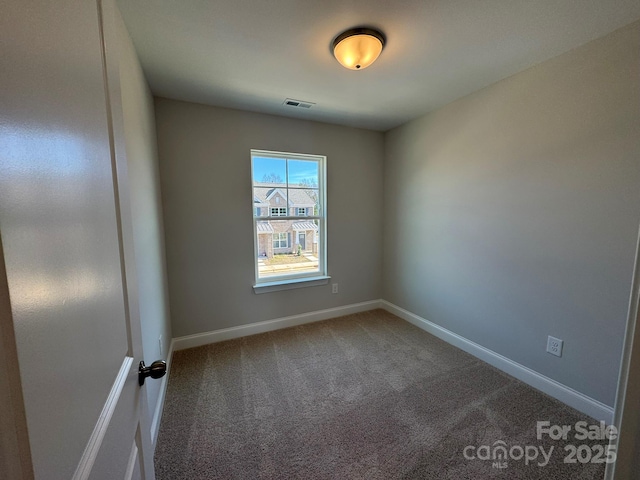 unfurnished room with baseboards, visible vents, and carpet flooring