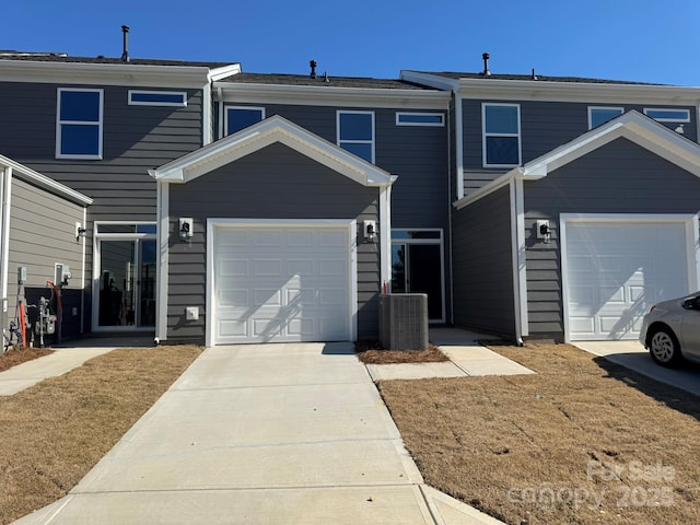 townhome / multi-family property featuring driveway and central AC