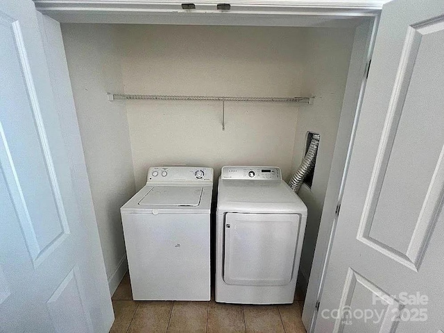 clothes washing area featuring washer and dryer and light hardwood / wood-style floors